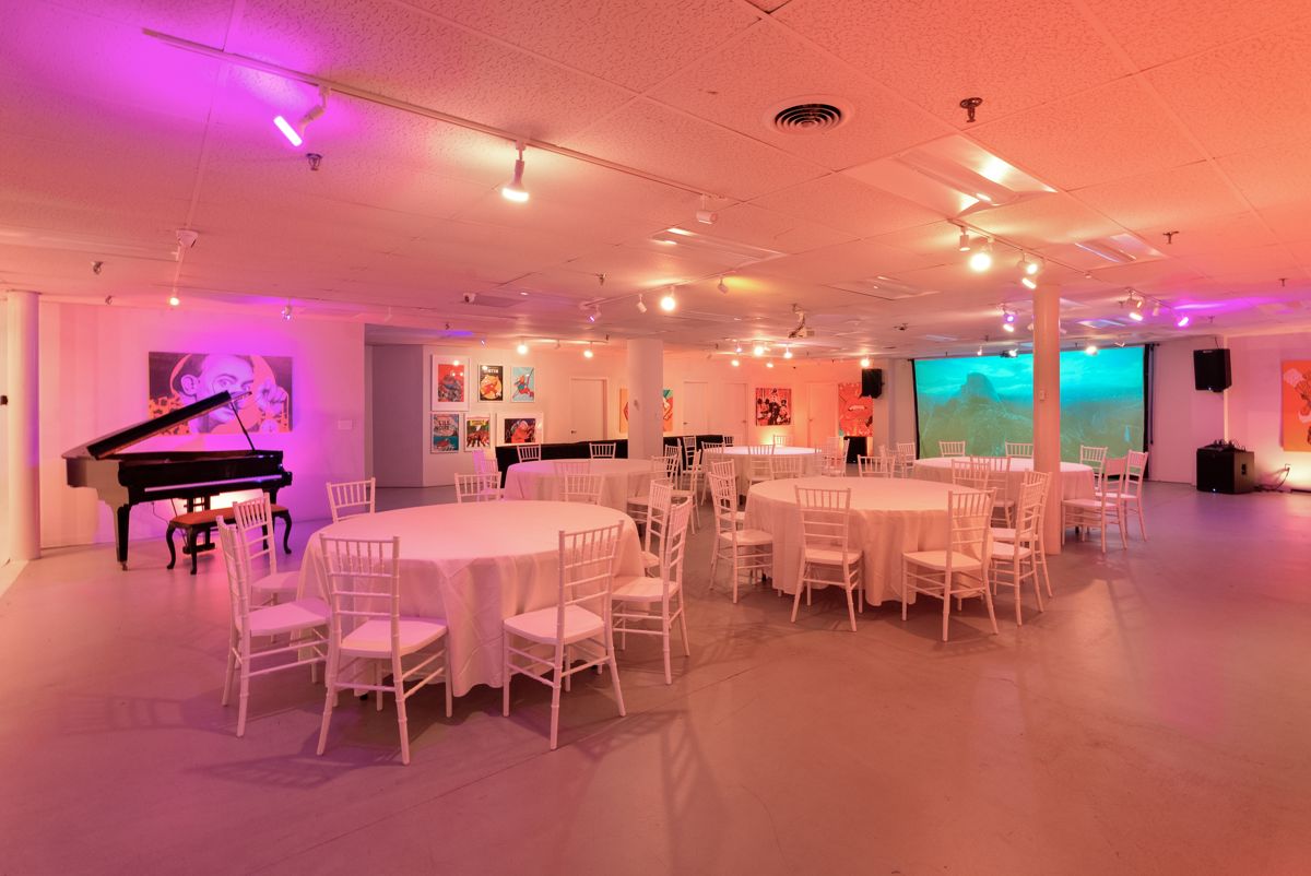 Round tables with cream linens and white Chiavari chairs