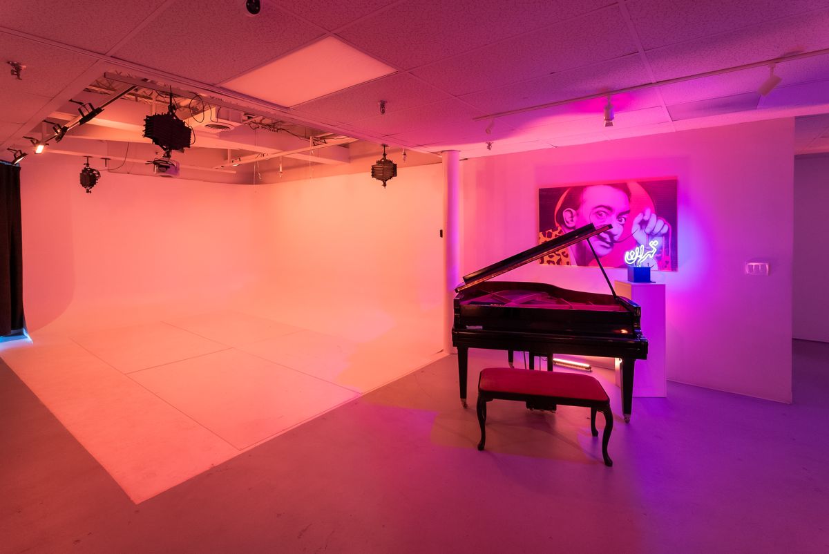 Grand piano under pink and amber light