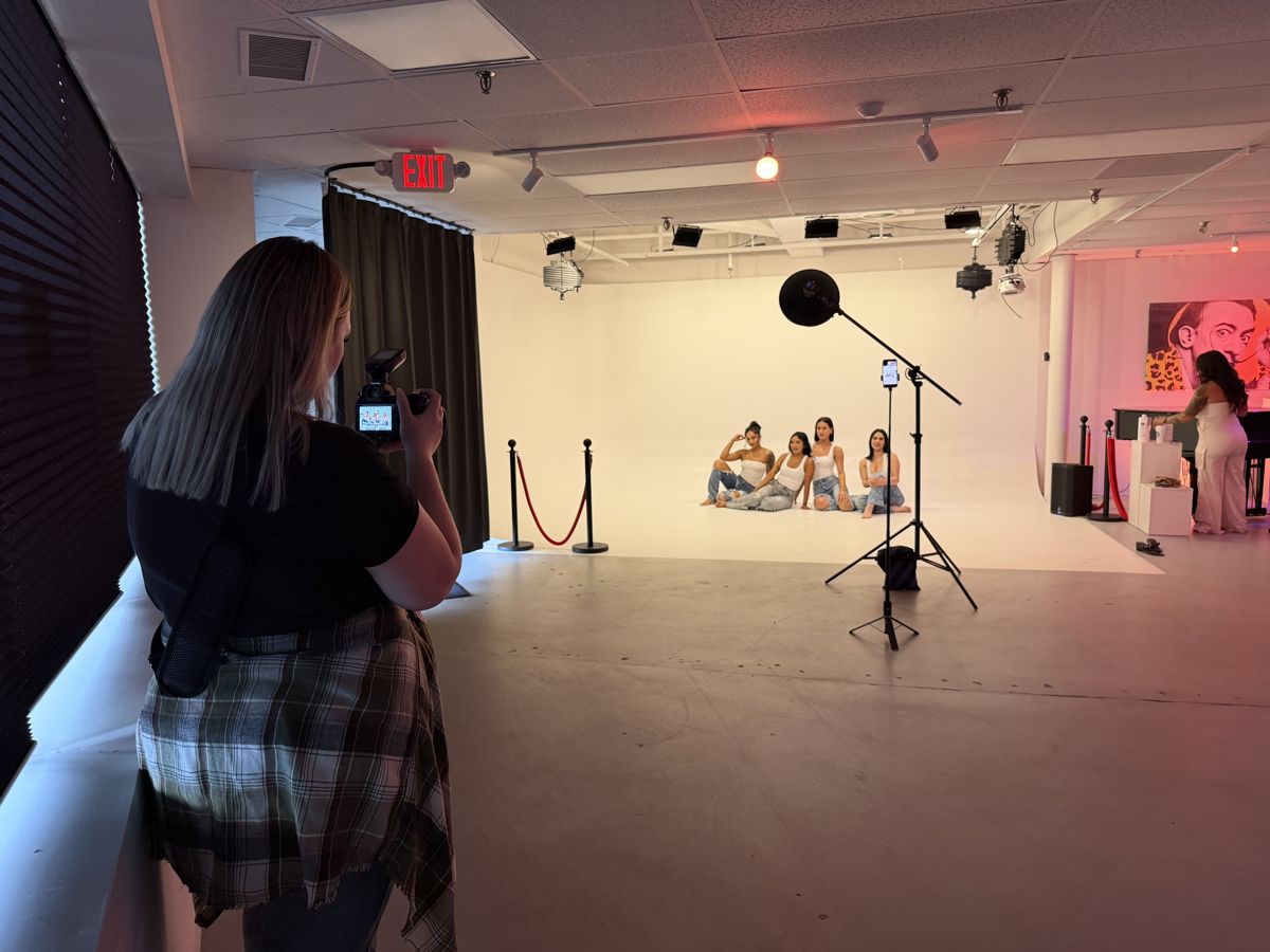 Content creators filming with a microphone in the studio area