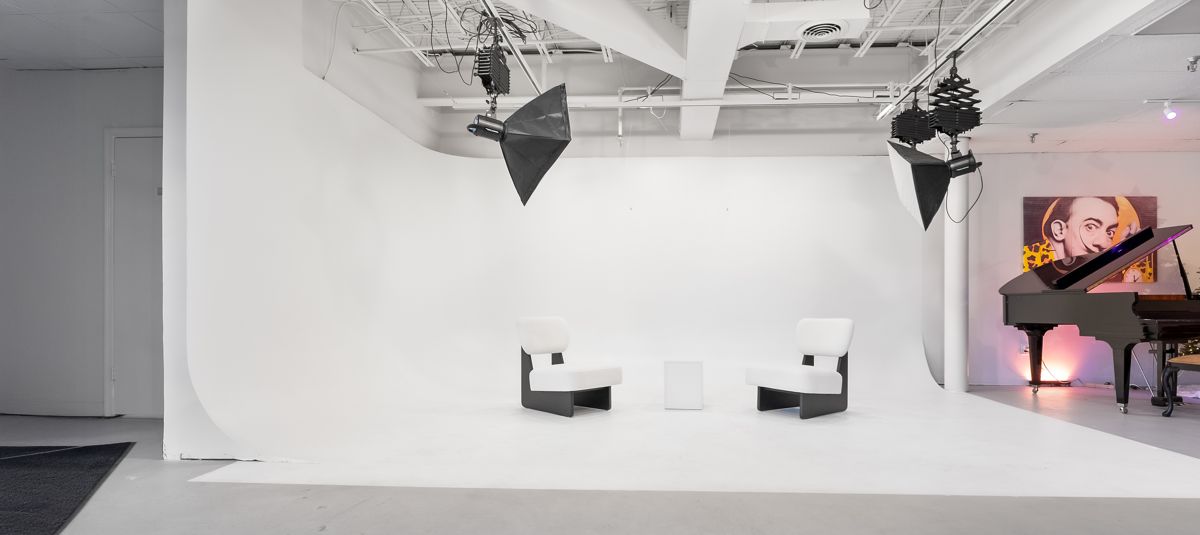 White cyclorama photo studio with lighting rig